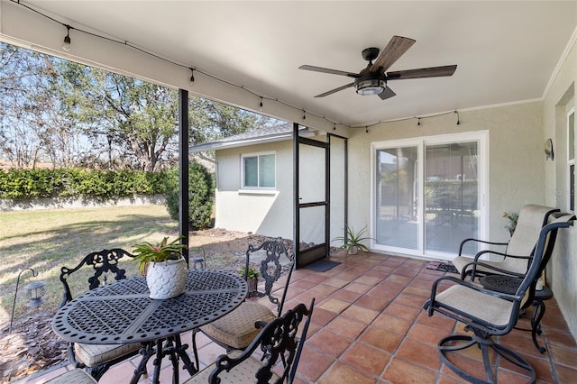 sunroom / solarium featuring ceiling fan