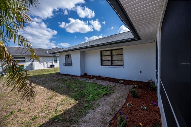 exterior space featuring a lawn and central air condition unit