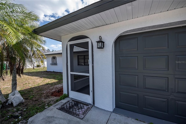 doorway to property featuring a garage