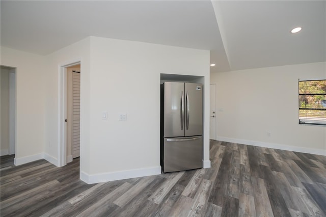 kitchen with dark wood-type flooring and stainless steel refrigerator