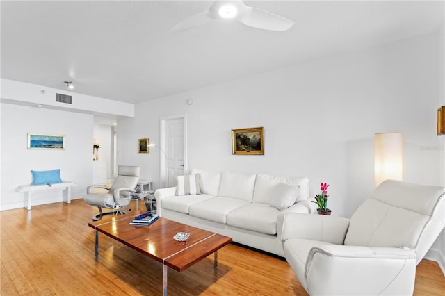 living room with ceiling fan and light hardwood / wood-style floors