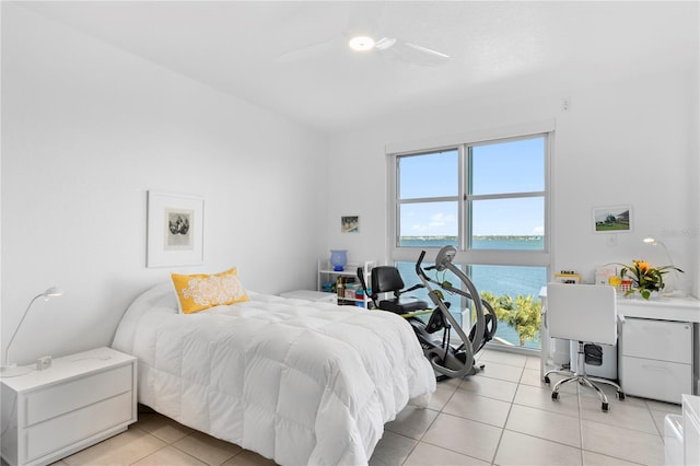 bedroom featuring a water view, ceiling fan, and light tile patterned floors