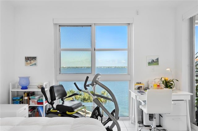 office space featuring light tile patterned floors and a water view