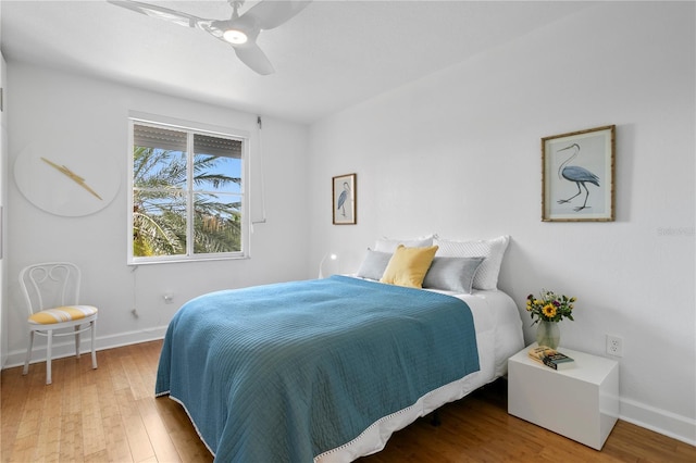 bedroom featuring hardwood / wood-style flooring and ceiling fan