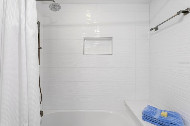 bathroom with shower / bath combo with shower curtain