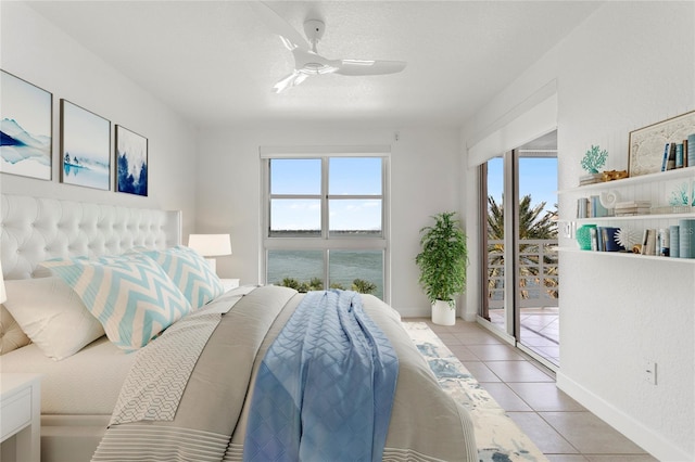 4993 Bacopa Ln S Unit 304, Saint Petersburg, FL 33715 - bedroom featuring a ceiling fan, access to outside, light tile patterned floors, and multiple windows