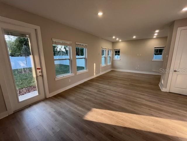 unfurnished living room featuring dark wood-type flooring