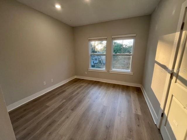 spare room with wood-type flooring