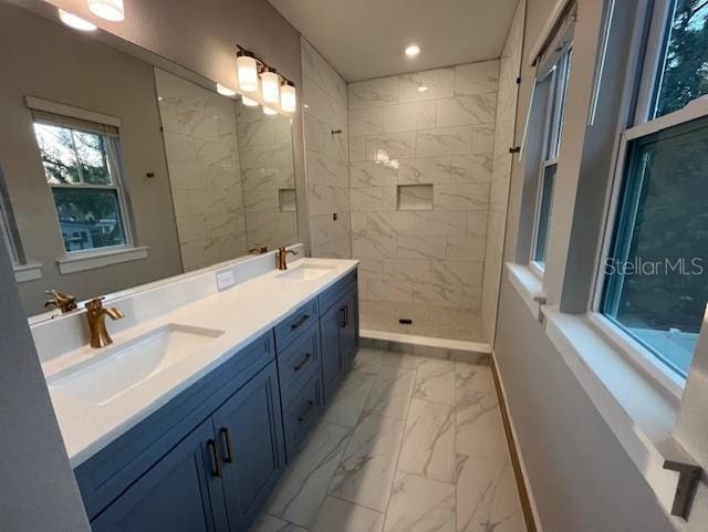 bathroom with vanity and tiled shower