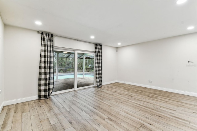 unfurnished room with light hardwood / wood-style floors