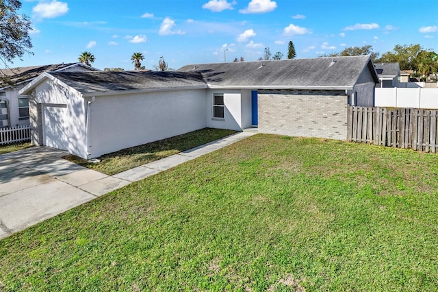 ranch-style house with driveway, an attached garage, fence, a front yard, and stucco siding