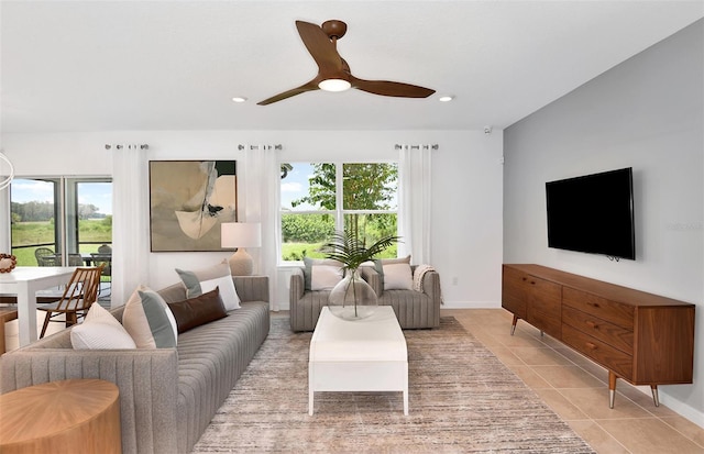 living room featuring ceiling fan and light tile patterned floors