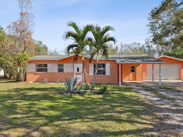 single story home with a garage, an outdoor structure, and a front yard