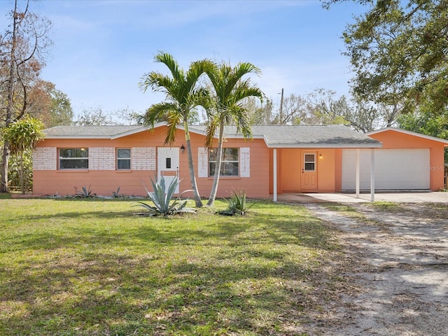 single story home featuring a front lawn and a garage