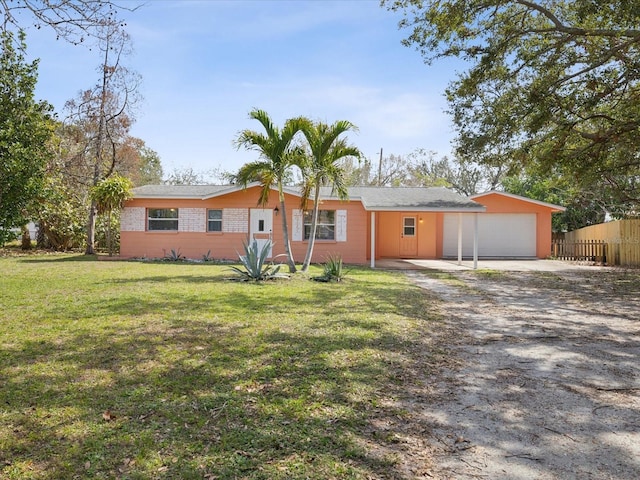 ranch-style home with a front lawn and a garage