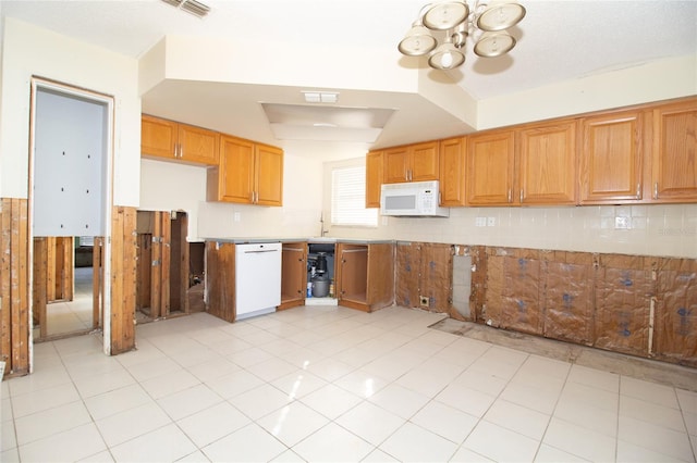 kitchen featuring tasteful backsplash, white appliances, sink, and light tile patterned floors