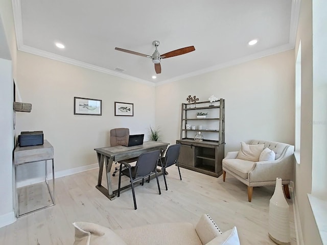 office space featuring crown molding, light hardwood / wood-style floors, and ceiling fan