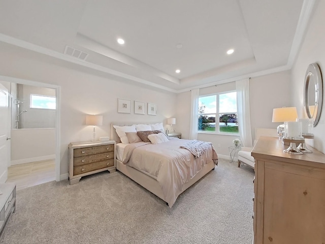 carpeted bedroom with a raised ceiling