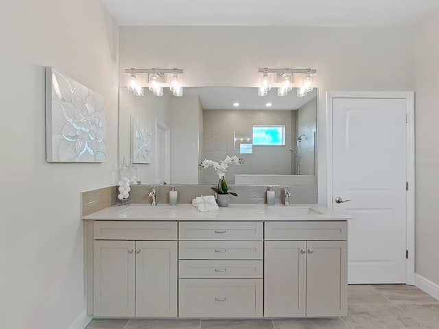 bathroom with vanity and a tile shower