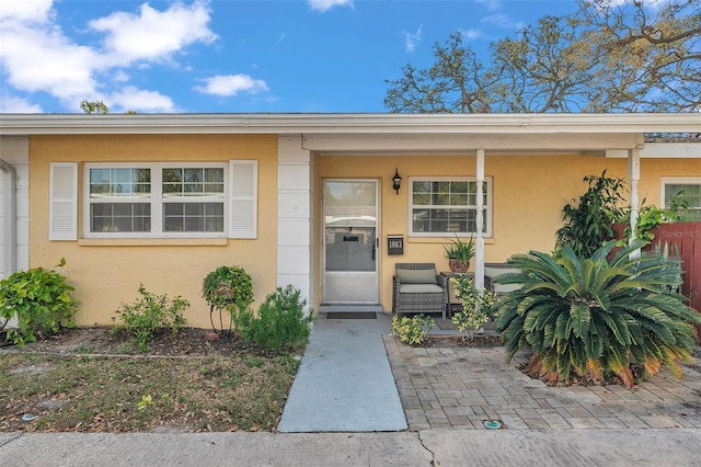 view of exterior entry featuring stucco siding