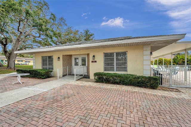 view of front of home featuring fence and stucco siding