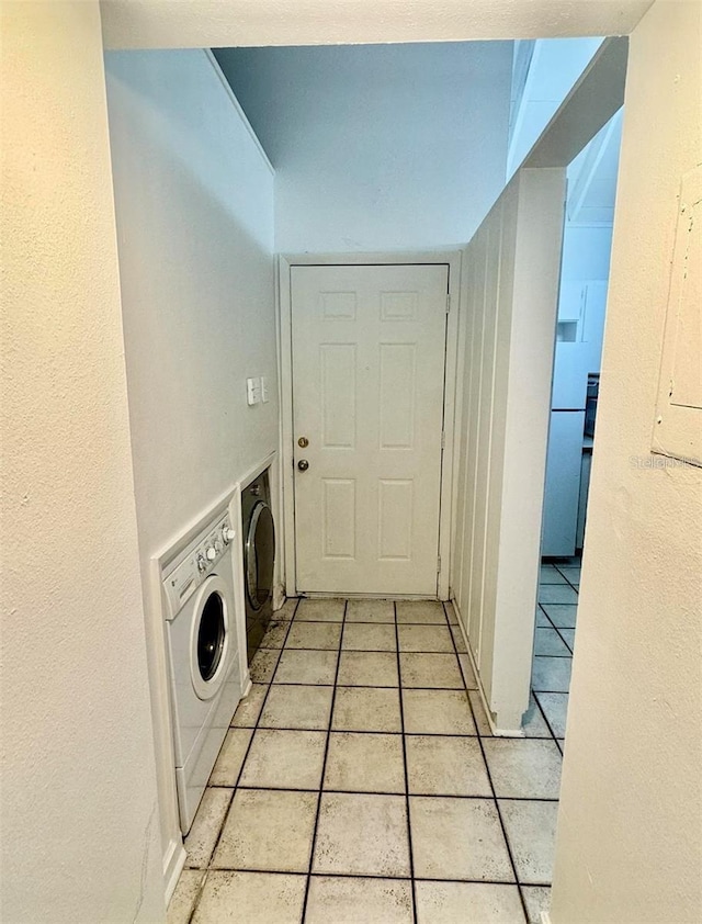 washroom featuring light tile patterned flooring and washer / dryer