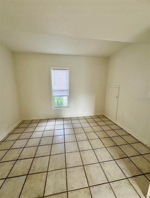 empty room with light tile patterned floors