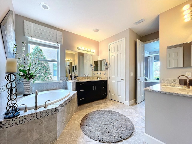 full bathroom with two vanities, visible vents, a sink, and a bath