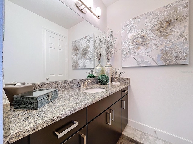 bathroom with baseboards and vanity