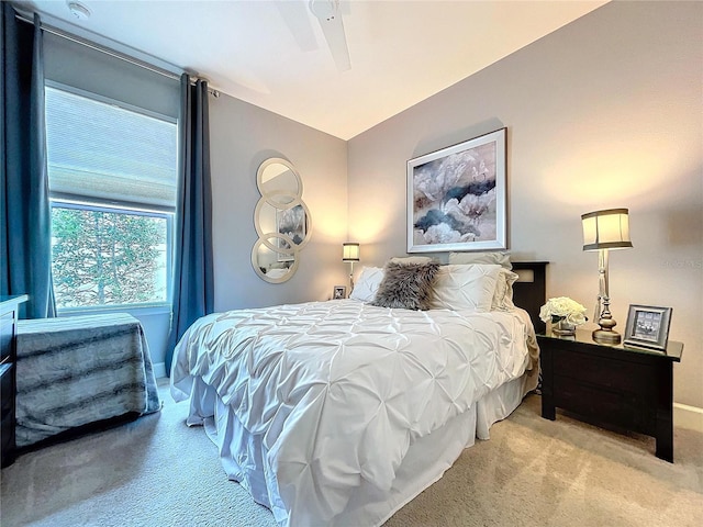 bedroom featuring carpet floors, lofted ceiling, ceiling fan, and baseboards