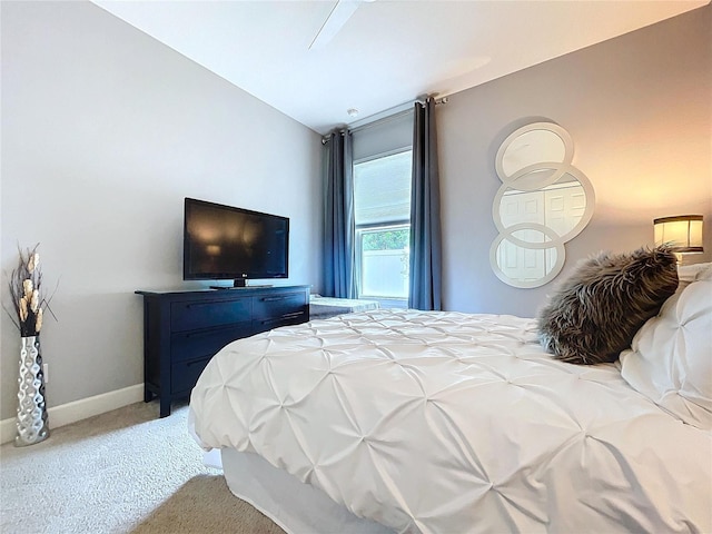 bedroom featuring light carpet and baseboards