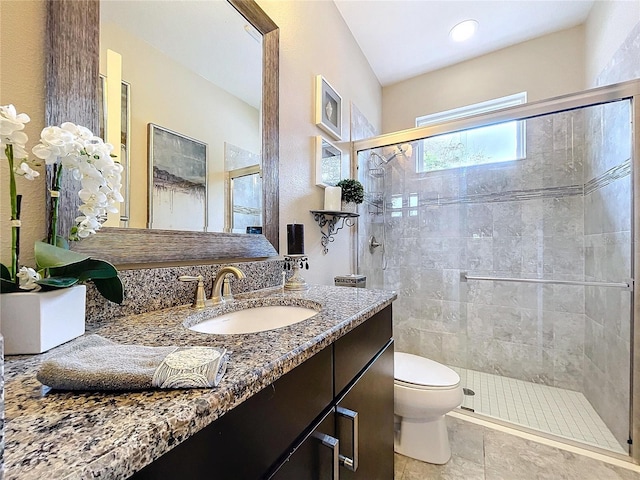 bathroom featuring a stall shower, vanity, and toilet