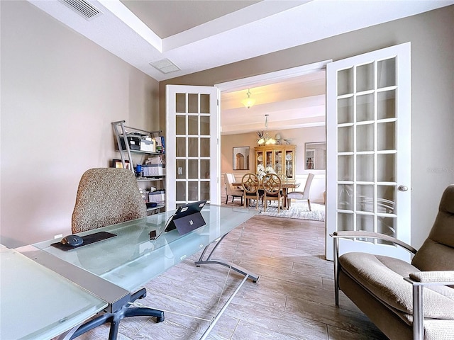 office space featuring french doors, wood finish floors, and visible vents