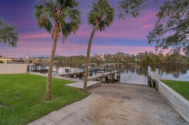 dock area featuring a water view and a yard