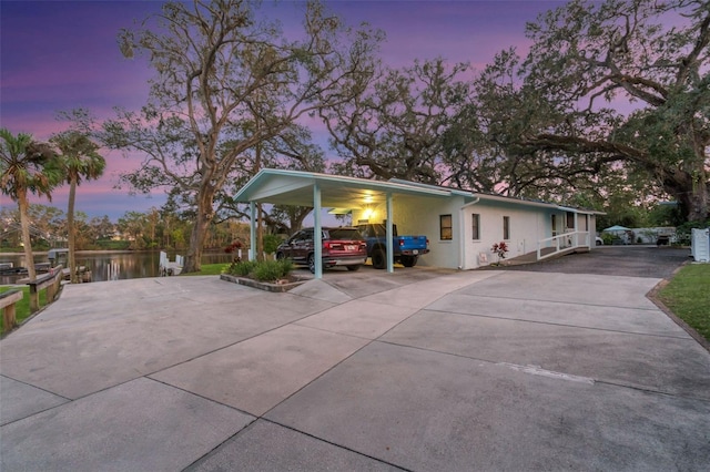10501 Bridgewood Dr, Riverview, FL 33578 - property exterior at dusk with a carport and a water view