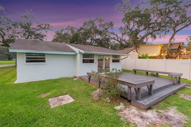 10501 Bridgewood Dr, Riverview, FL 33578 - back house at dusk featuring a yard and a deck