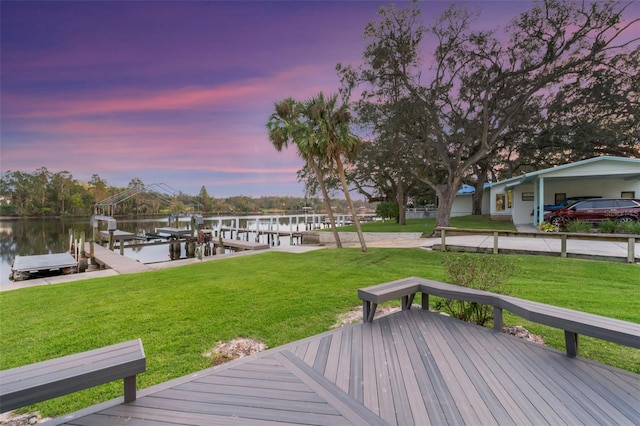 10501 Bridgewood Dr, Riverview, FL 33578 - deck at dusk featuring a water view, a boat dock, and a lawn