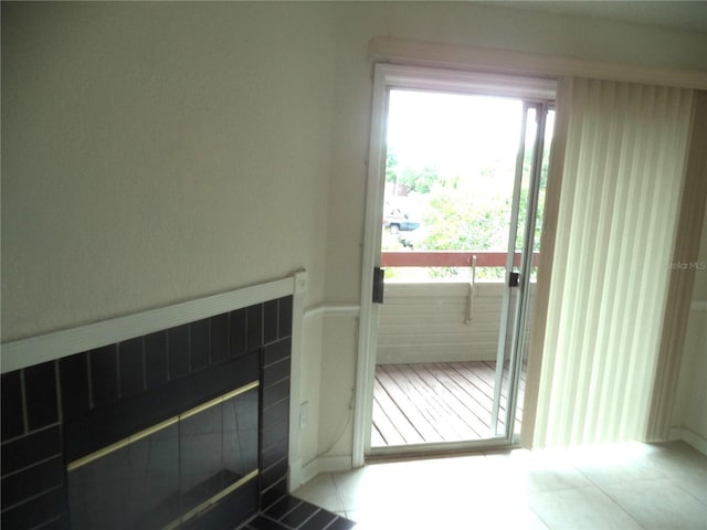 doorway to outside featuring tile patterned flooring and a tiled fireplace