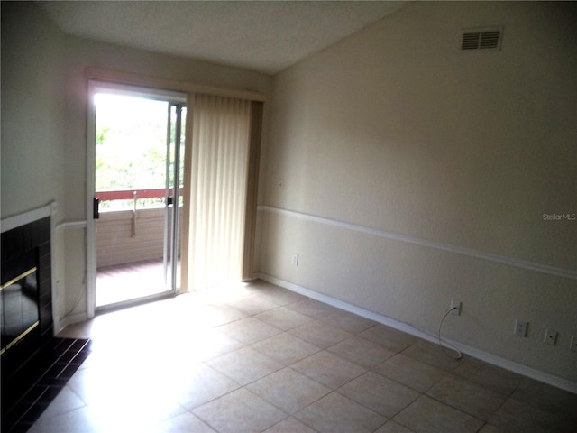 unfurnished living room with a tile fireplace