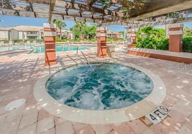 view of swimming pool featuring a pergola, a community hot tub, and a patio