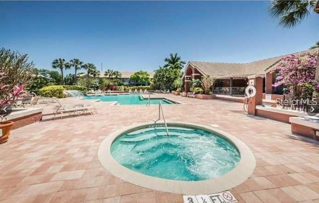 view of swimming pool with a patio and a community hot tub