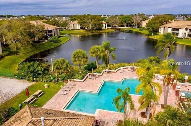 view of pool featuring a water view and a patio area