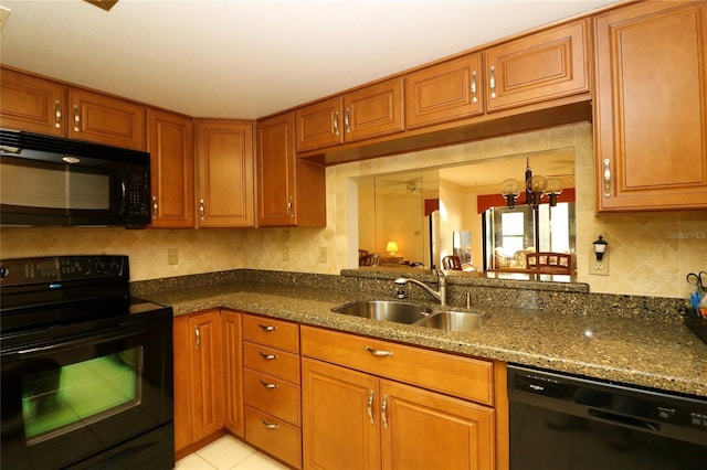 kitchen with sink, tasteful backsplash, an inviting chandelier, dark stone countertops, and black appliances