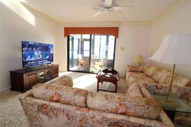 living room with crown molding, ceiling fan, and carpet flooring