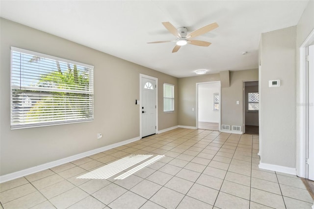 foyer featuring light tile patterned floors and ceiling fan