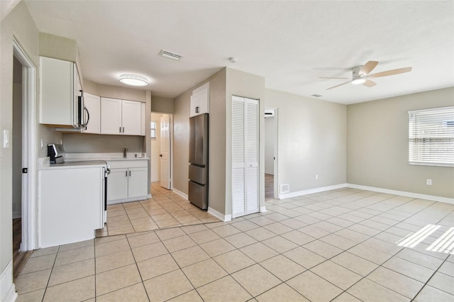 kitchen featuring white cabinetry, appliances with stainless steel finishes, light tile patterned floors, and ceiling fan