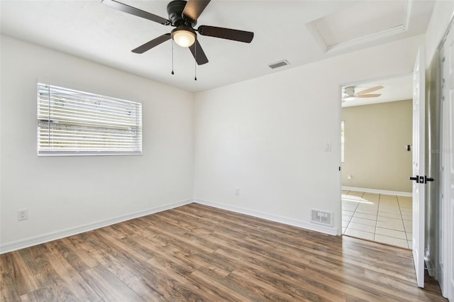 empty room with hardwood / wood-style flooring and plenty of natural light