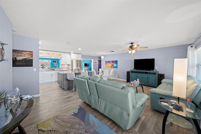 9911 Antilles Dr, Seminole, FL 33776 - living room featuring recessed lighting, baseboards, ceiling fan, and light wood finished floors