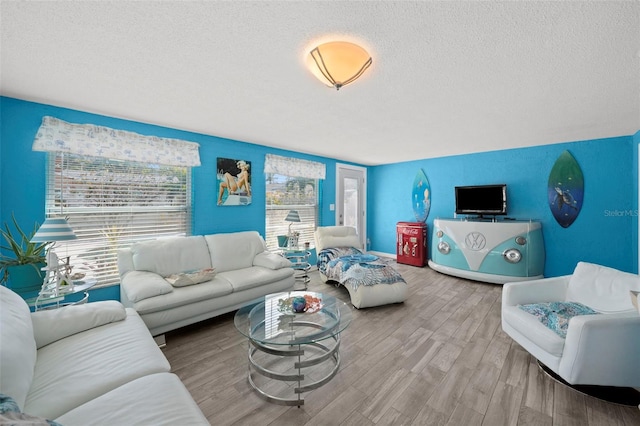 9911 Antilles Dr, Seminole, FL 33776 - living area featuring a textured ceiling and wood finished floors