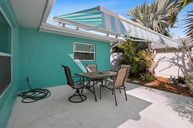 9911 Antilles Dr, Seminole, FL 33776 - view of patio with outdoor dining space and fence